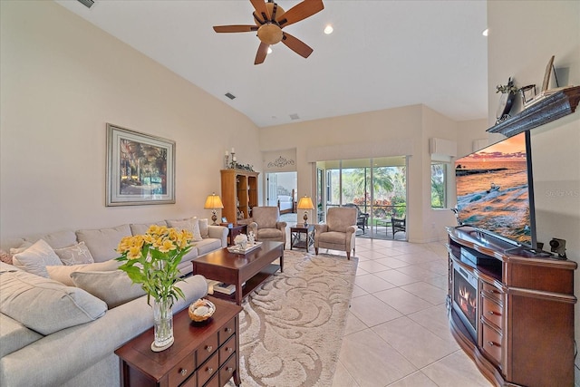 living room with a towering ceiling, ceiling fan, and light tile patterned flooring