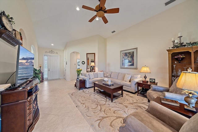 tiled living room with ceiling fan and high vaulted ceiling