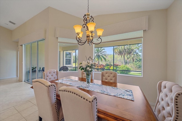 tiled dining room with lofted ceiling and a chandelier