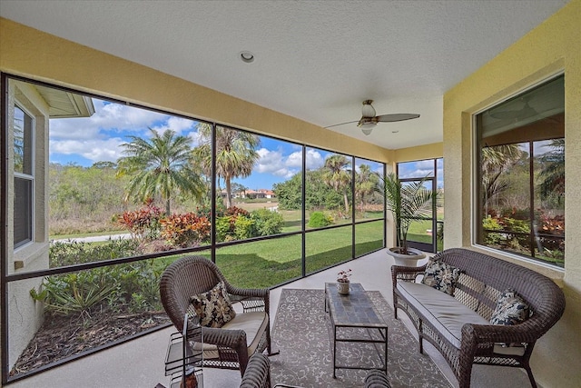 sunroom featuring ceiling fan