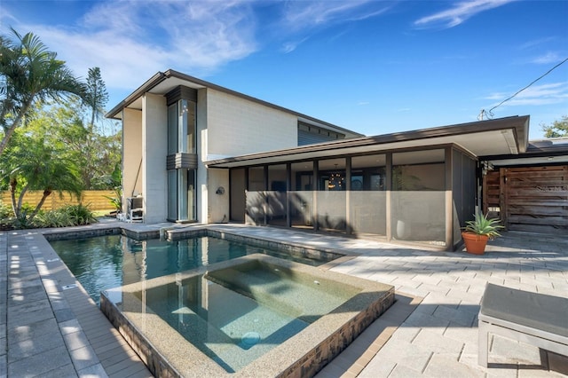 view of swimming pool featuring an in ground hot tub and a patio