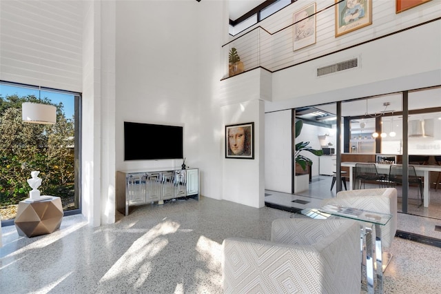 living room featuring a towering ceiling