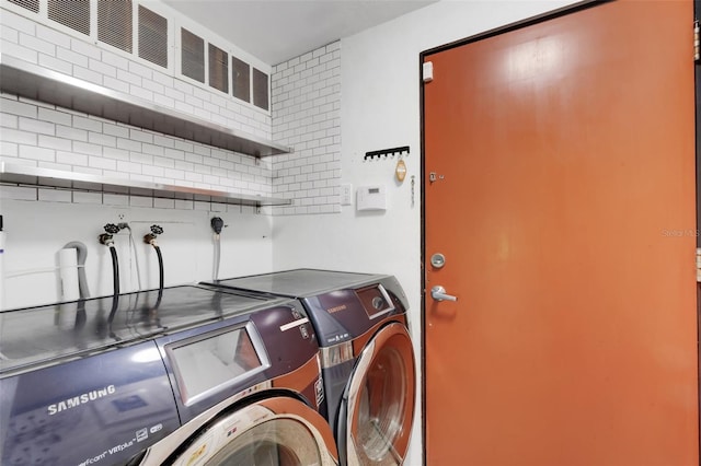 washroom featuring washer and clothes dryer