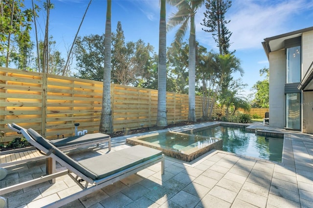 view of pool with an in ground hot tub and a patio area