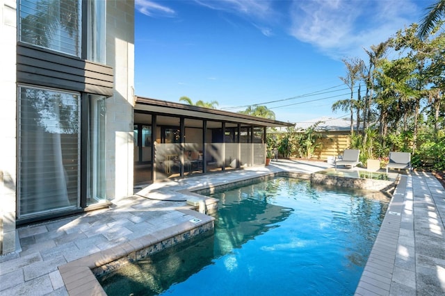 view of swimming pool with a patio