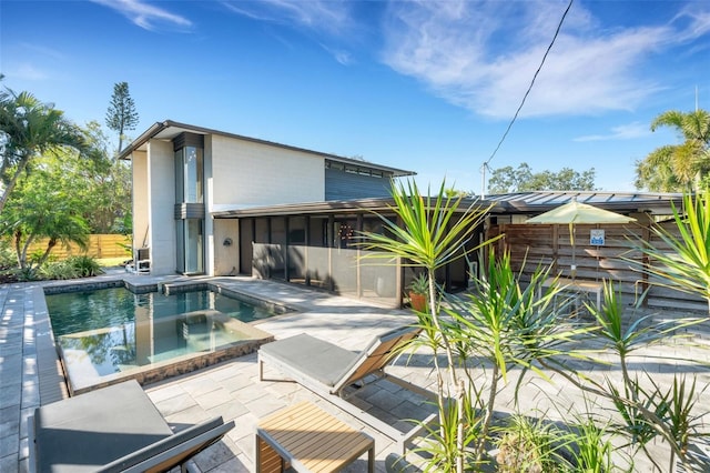 view of swimming pool with an in ground hot tub and a patio