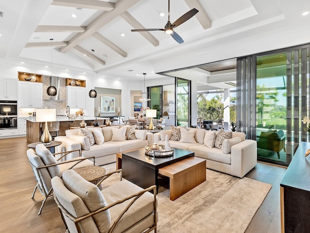 living area with ceiling fan, light wood-type flooring, high vaulted ceiling, beam ceiling, and recessed lighting