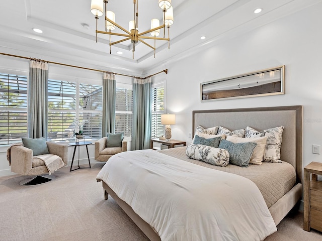 bedroom with a notable chandelier, a tray ceiling, carpet flooring, and recessed lighting