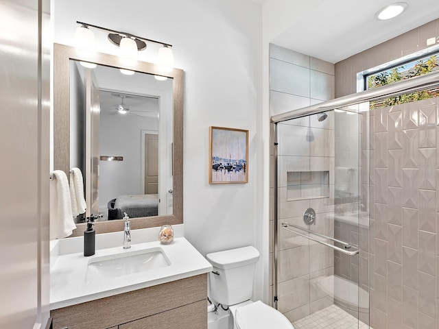 bathroom featuring toilet, a shower stall, vanity, and ensuite bathroom