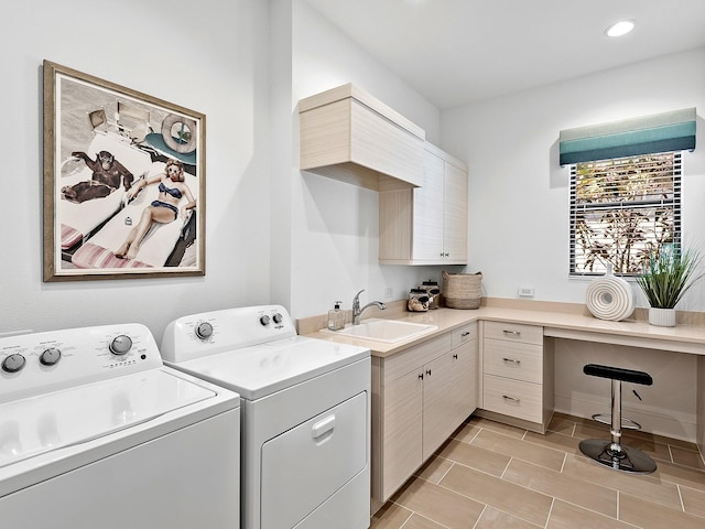 washroom featuring separate washer and dryer, a sink, cabinet space, and recessed lighting