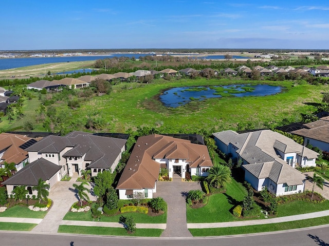 birds eye view of property with a residential view and a water view