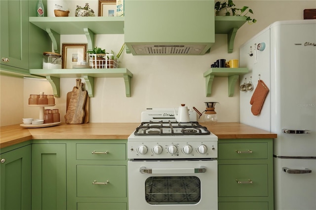 kitchen featuring white appliances, green cabinetry, and open shelves