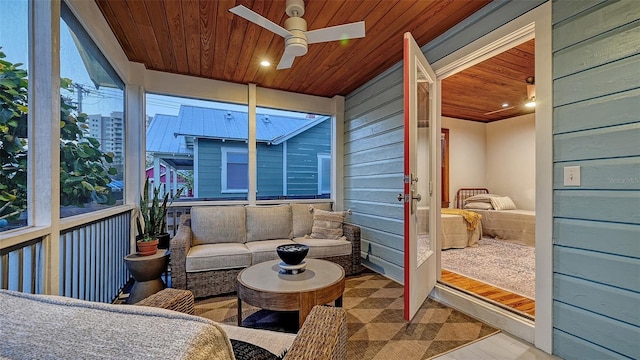 sunroom / solarium featuring wood ceiling and a ceiling fan