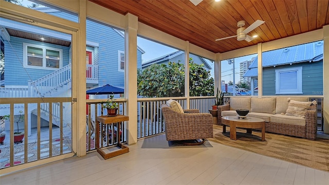 sunroom / solarium with wood ceiling and ceiling fan