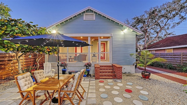 rear view of property with a patio area and fence