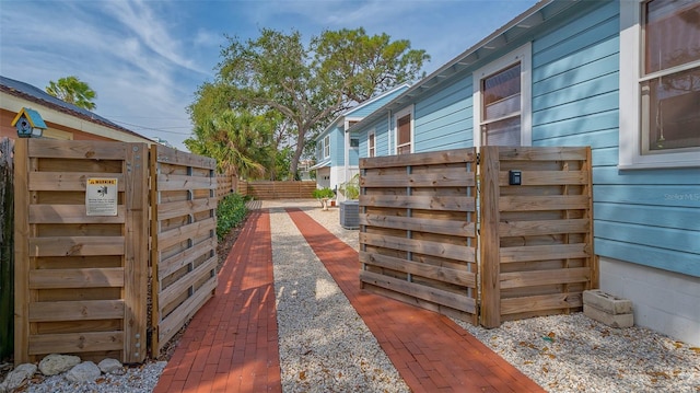 view of side of property with fence and central air condition unit