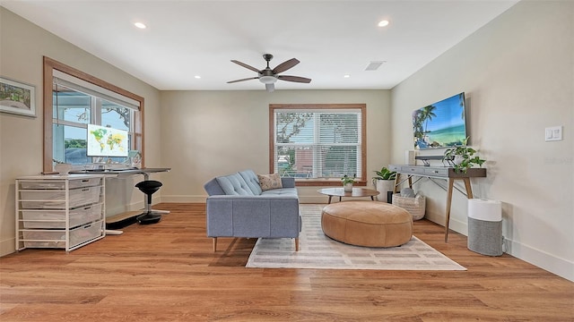 living area with light wood-style floors, visible vents, and plenty of natural light