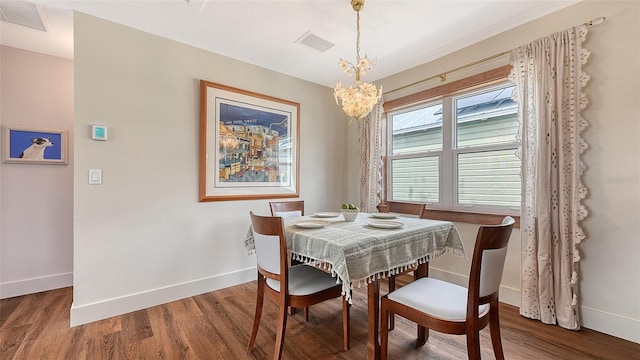 dining room featuring baseboards, visible vents, and wood finished floors