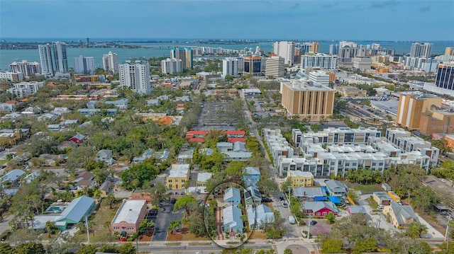 birds eye view of property with a water view and a view of city