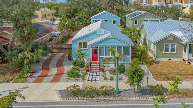 view of front of house with a residential view, decorative driveway, and fence