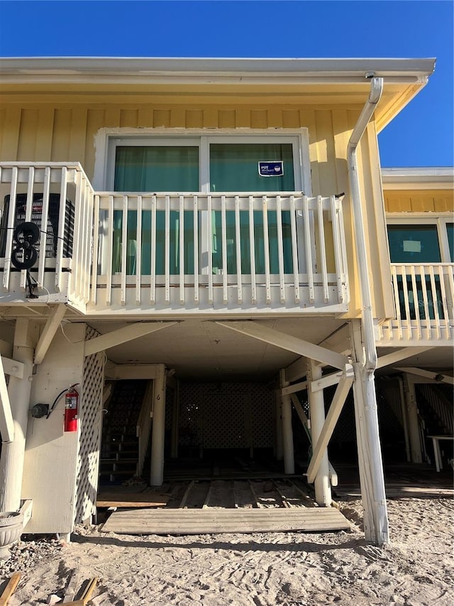 entrance to property with a carport and a balcony