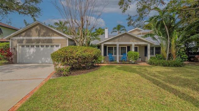 view of front of property with a garage, a front yard, and a porch