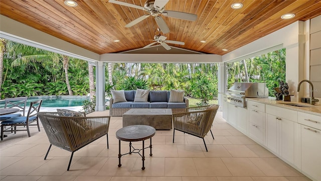 view of patio with an outdoor kitchen, sink, outdoor lounge area, ceiling fan, and grilling area