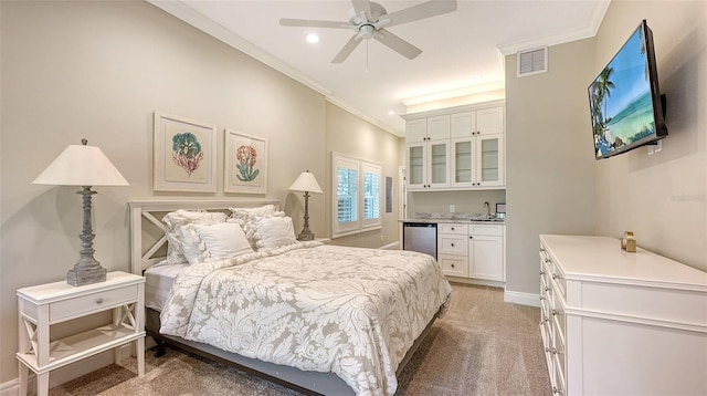 bedroom featuring ornamental molding, carpet, wet bar, and ceiling fan