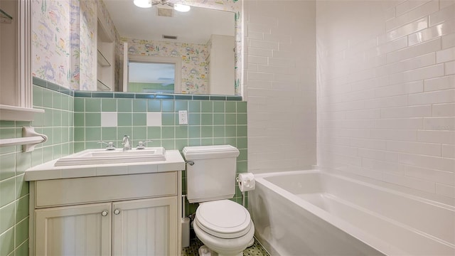 full bathroom featuring tile walls, vanity, shower / bathtub combination, and toilet