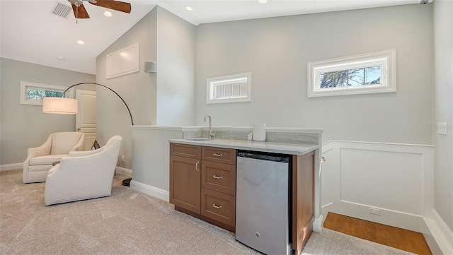 interior space featuring lofted ceiling, sink, stainless steel refrigerator, ceiling fan, and light colored carpet