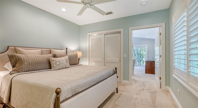 carpeted bedroom featuring ceiling fan and a closet