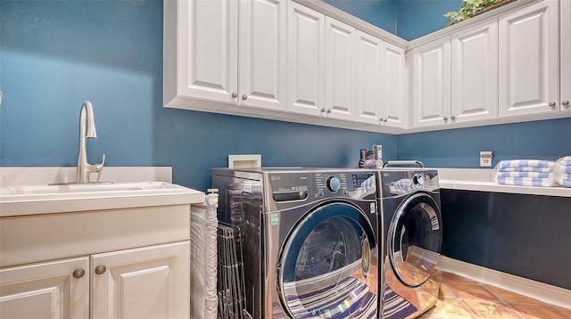 laundry area with cabinets, separate washer and dryer, sink, and tile patterned flooring