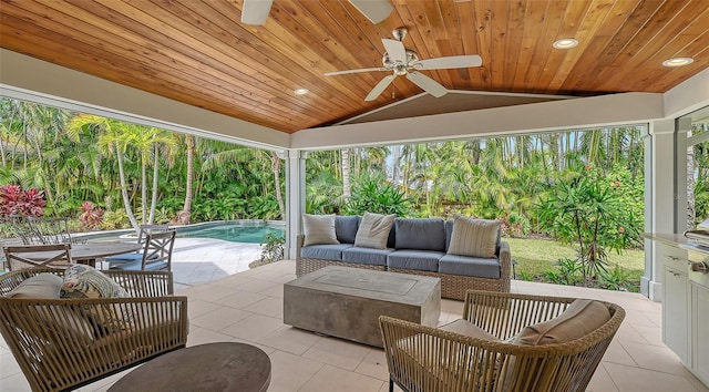 sunroom featuring ceiling fan, outdoor lounge area, and a patio