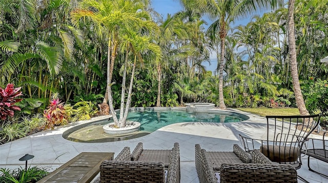 view of pool with a patio and an in ground hot tub