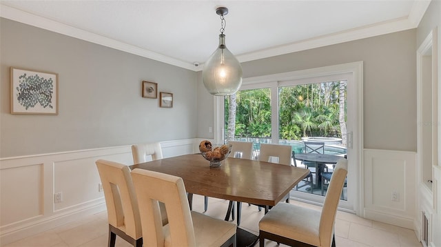 dining room featuring light tile patterned floors and ornamental molding