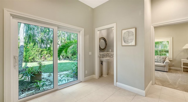 doorway with light colored carpet