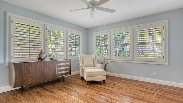 living area with ceiling fan and light hardwood / wood-style floors