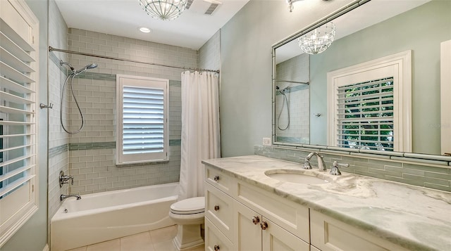 full bathroom with tile patterned floors, toilet, an inviting chandelier, shower / tub combo, and vanity