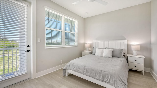 bedroom featuring multiple windows, ceiling fan, and light wood-type flooring