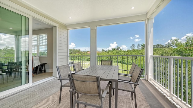 sunroom / solarium featuring wood finished floors