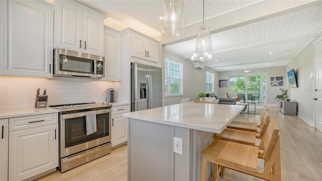 kitchen with stainless steel appliances, tasteful backsplash, wooden ceiling, light wood-style flooring, and open floor plan