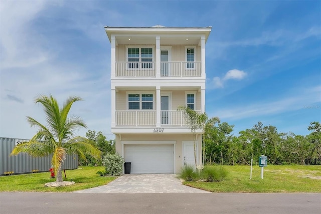 4207 Marina View Way, Cortez, FL 34215 - raised beach house with a balcony, driveway, a front lawn, and a garage