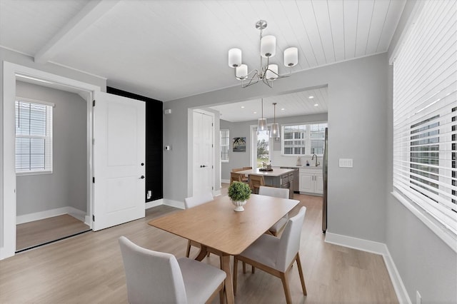 4207 Marina View Way, Cortez, FL 34215 - dining area featuring a chandelier, light wood-style flooring, healthy amount of natural light, and a wooden ceiling with exposed beams
