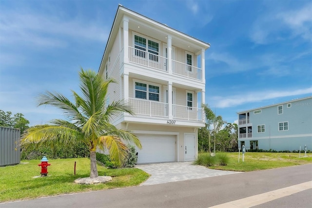 4207 Marina View Way, Cortez, FL 34215 - beach home with a balcony, an attached garage, a front lawn, and driveway