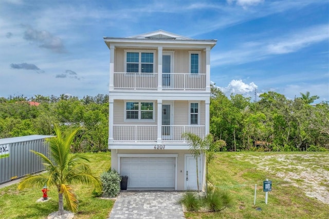 4207 Marina View Way, Cortez, FL 34215 - raised beach house with a balcony, driveway, a garage, and a front yard