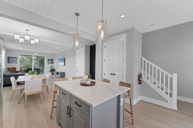 4207 Marina View Way, Cortez, FL 34215 - kitchen with gray cabinetry, light wood-style flooring, a breakfast bar area, a wooden ceiling with exposed beams, and open floor plan