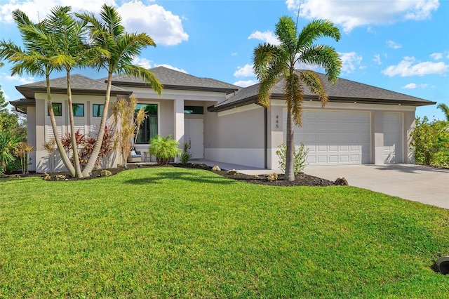 view of front of house featuring a garage and a front yard