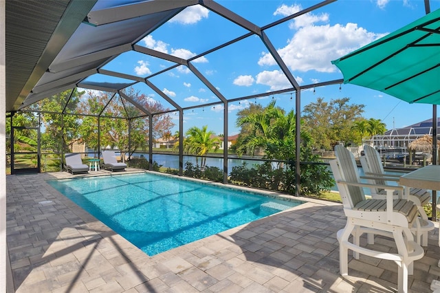 view of swimming pool with a water view, a patio, and glass enclosure