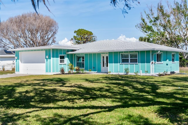 ranch-style house with a garage, a front yard, and covered porch