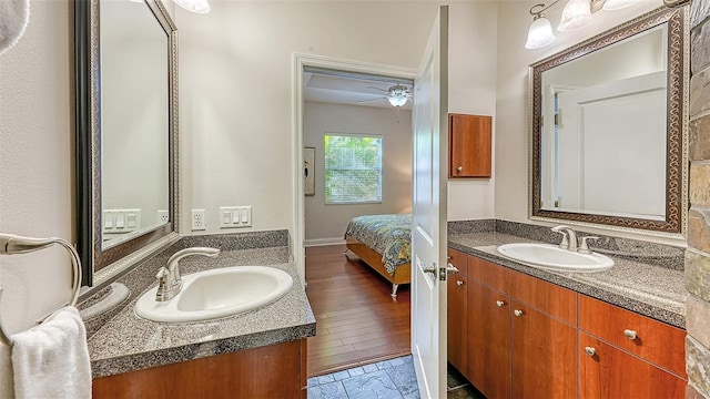 bathroom with ceiling fan, vanity, and hardwood / wood-style floors